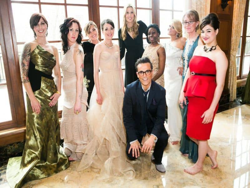 The women of Grace Centers look happy and proud after walking down the runway to help raise money for their shelter. The ladies are pictured with Luigi Bruni, who donated the services of his Michigan-based Luigi Bruni Salon for the show, and Mary Alice Stephenson, the founder of GLAM4GOOD.