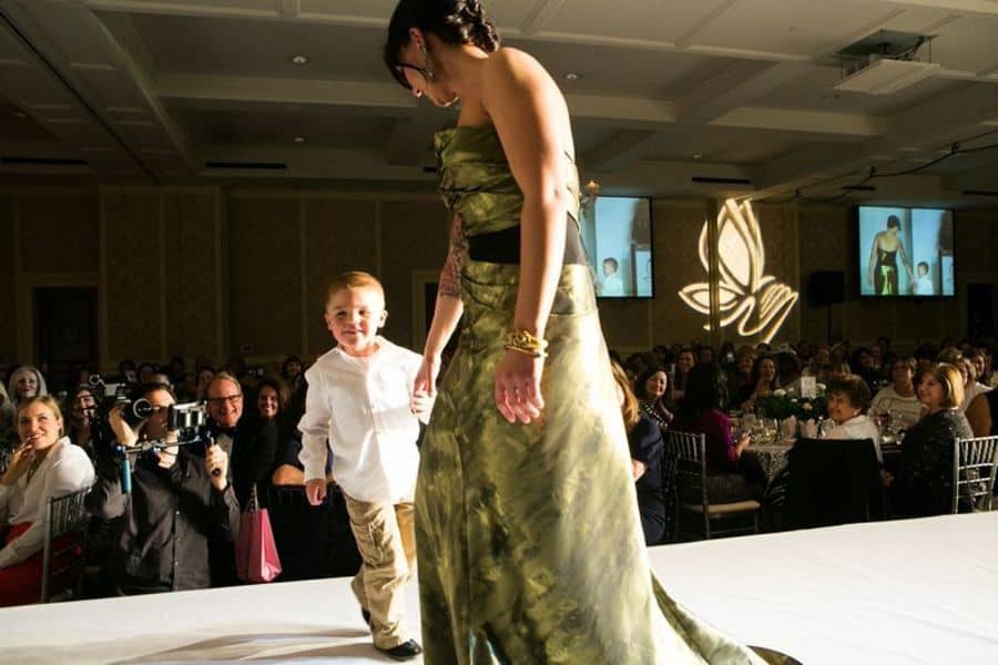 Rachel’s little boy jumped on the stage to give his mom a hug as soon as he saw her come down the runway! Dress by Bibhu Mohapatra. Jewelry by Alexis Bittar.