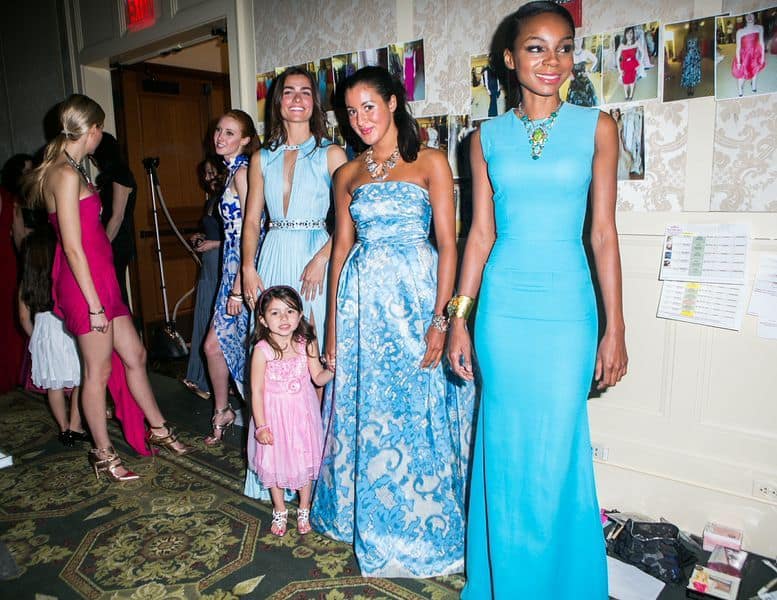 RGA Models wearing Versace, Viktor & Rolf and Victoria Beckham from Albright and Alexis Bittar jewelry walked the runway with kids living at the shelter. 